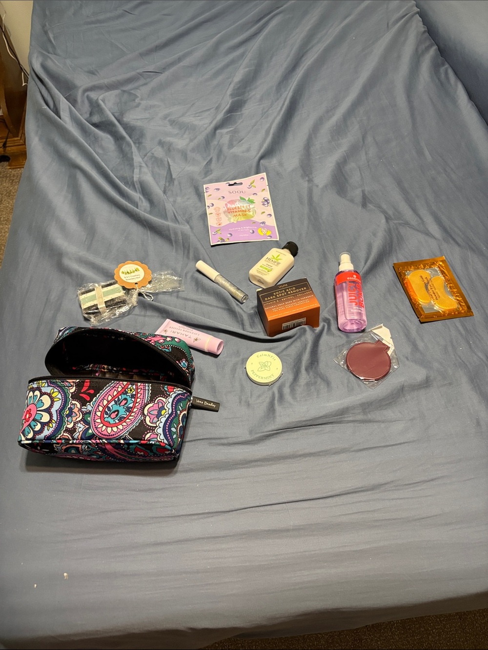 Vera Bradley bag with body care items with body, face, eyes, lips, hands etc